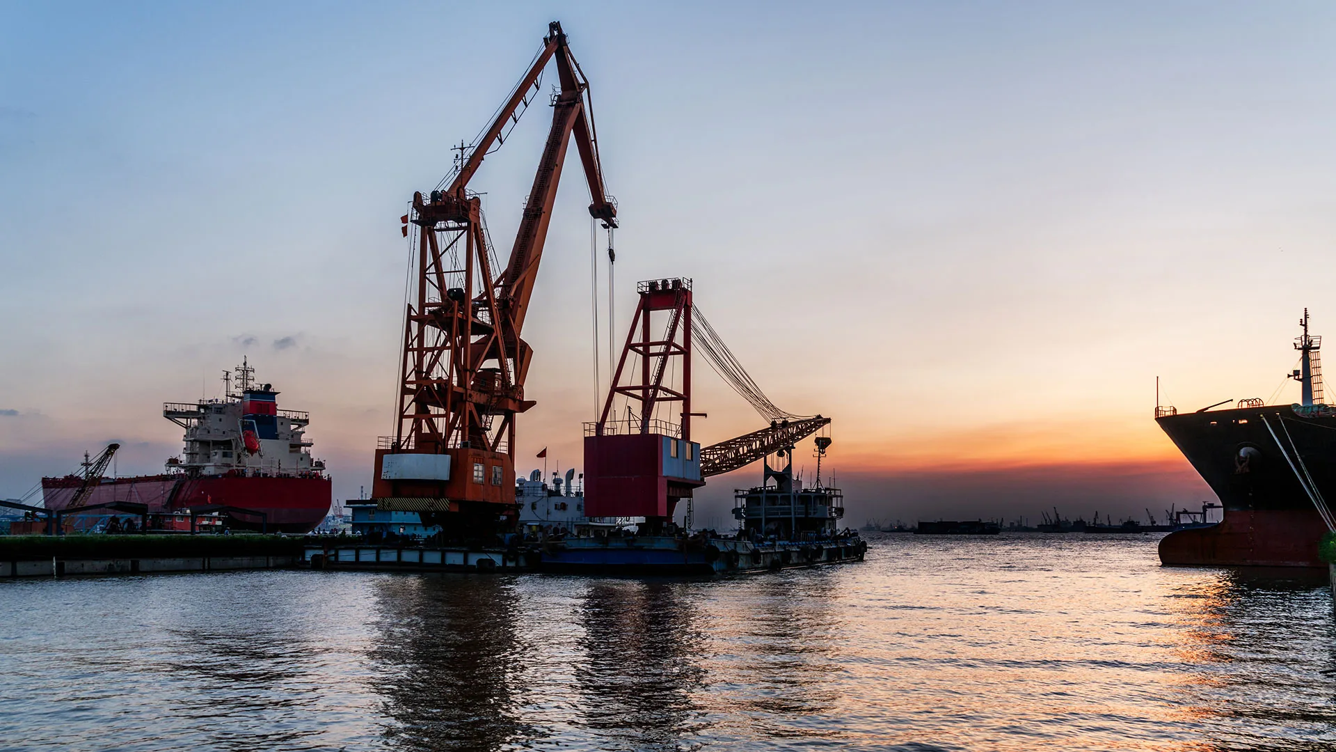 Port cranes at sunset